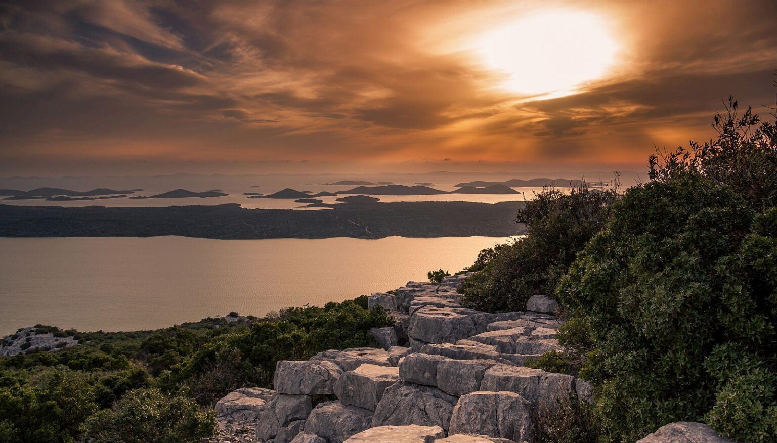 Sunset over the sea from viewpoint Kamenjak in the Vrana Lake nature park, Croatia.